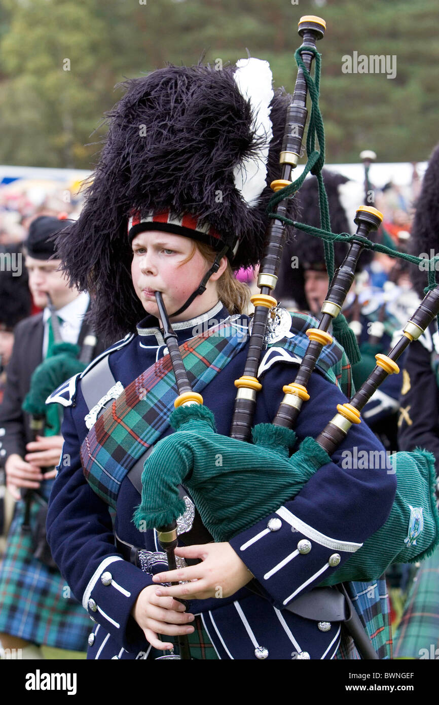 Marching massed pipe band with bagpipes at the Braemar Games Highland