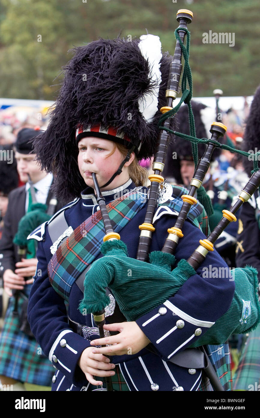 Marching massed pipe band with bagpipes at the Braemar Games Highland gathering Stock Photo