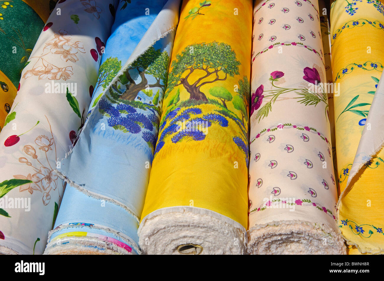Various rolls of colorful provencal fabrics at market, Sault, provence