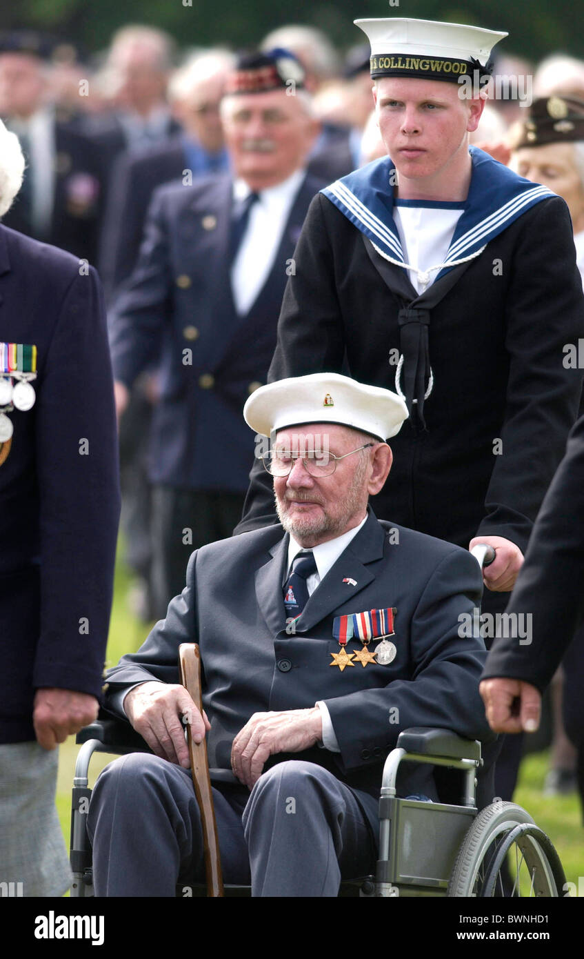 Disabled veteran of the D-Day Landings wheeled in a wheelchair in a parade at the start of the 60th Anniversary Commemorations. Stock Photo