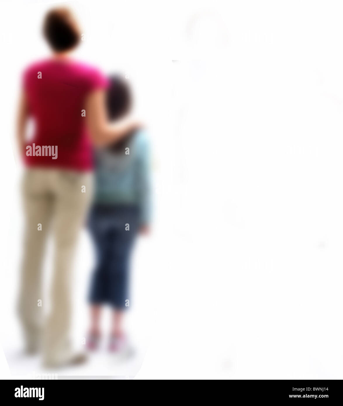 Back view of a mother and young daughter, back view blurred. Stock Photo