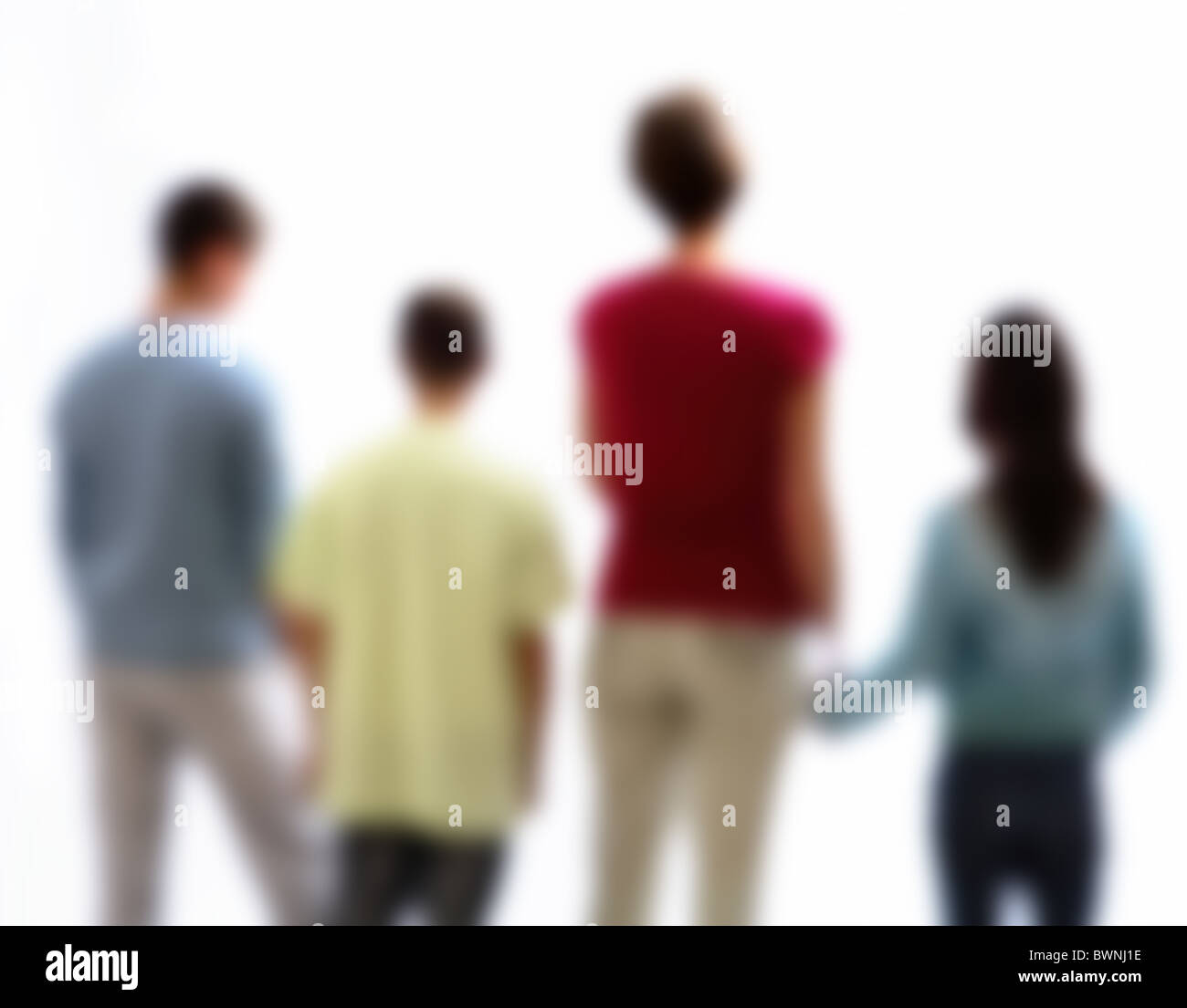Back view of a family, mother with two boys and a girl, back view soft focus. Stock Photo