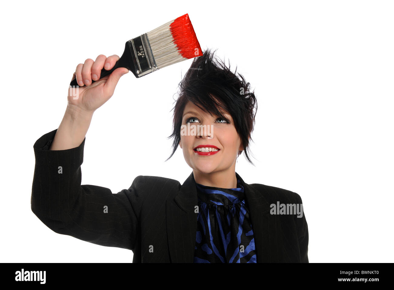 Beautiful businesswoman with paintbrush with red paint isolated over white background Stock Photo