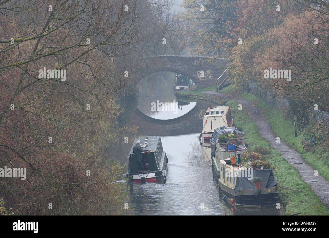 Narrowboats on the Oxford canal on a foggy day in Wolvercote. Stock Photo