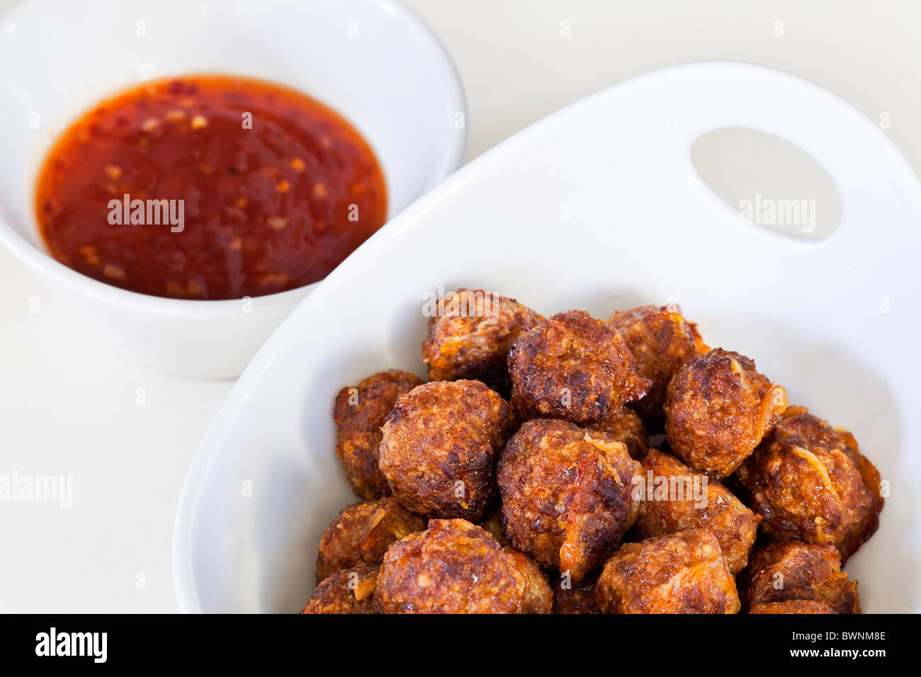 Spicy meatballs and a hot sauce, appetizer. Stock Photo