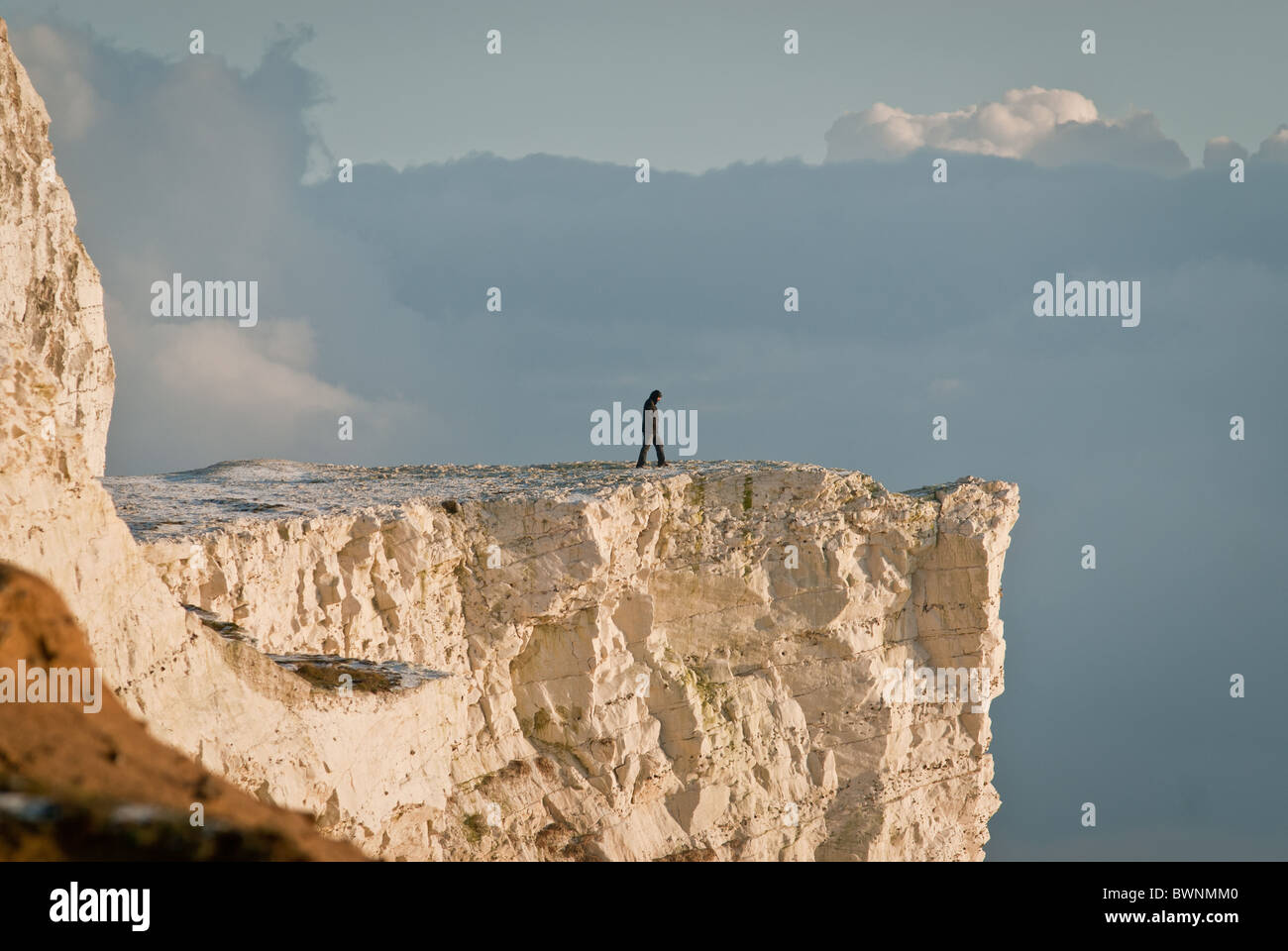 Man walkni9g to cliff edge Stock Photo