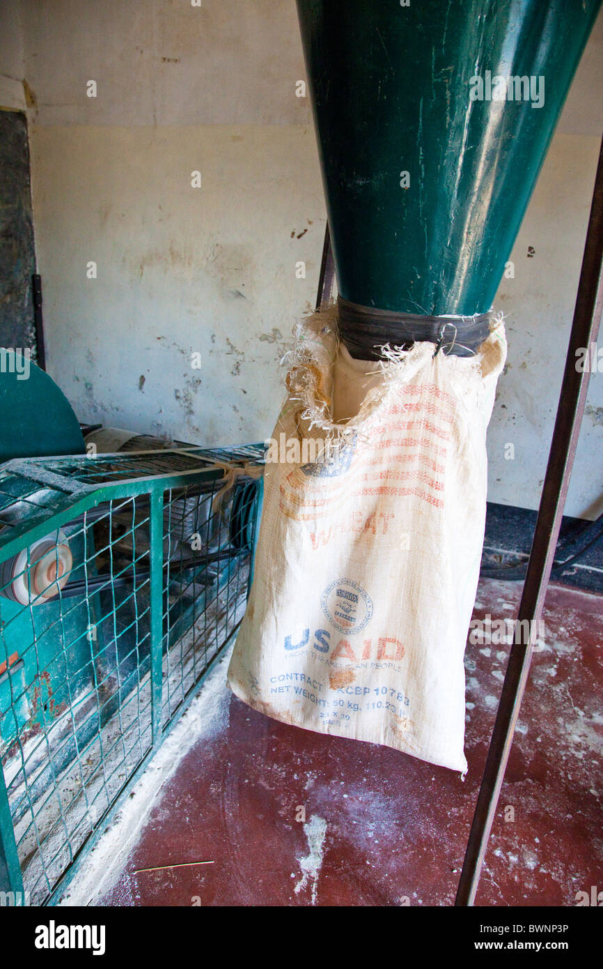 Posho mill, USAID bag being re-used, grinding corn to flour in Nairobi, Kenya Stock Photo