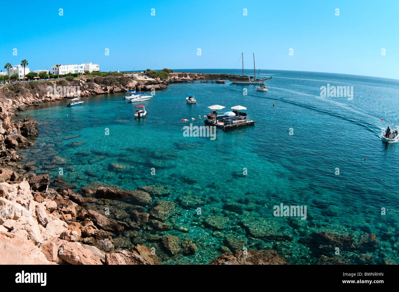 Bay for scuba diving in the Mediterranean sea with motor boats and a platform for diving. People go on a vessel Stock Photo