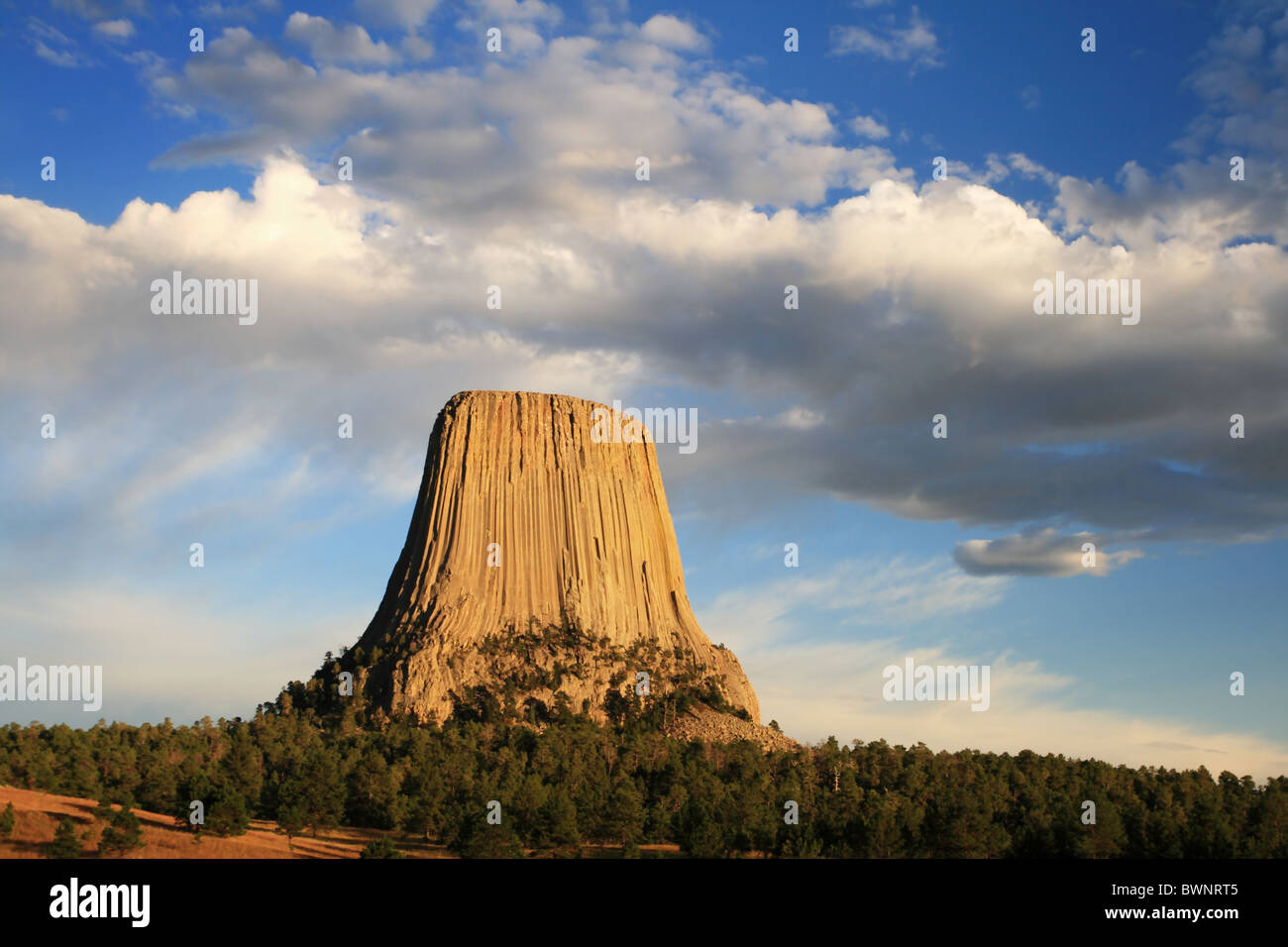 devils tower national monument in wyoming with late afternoon light and clouds Stock Photo