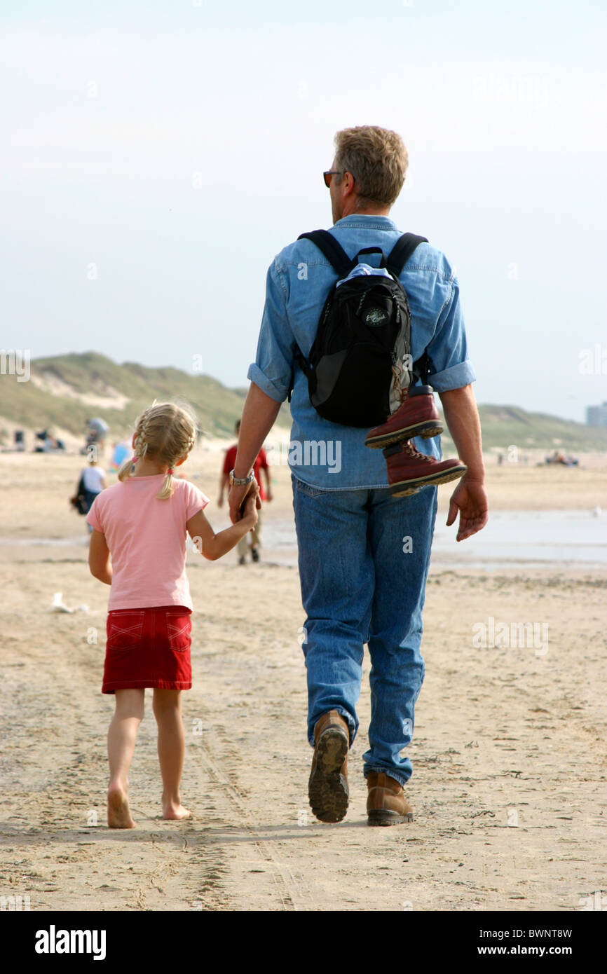 Parent And Child Holding Hands Walking Away Backpack Stock Photo Alamy
