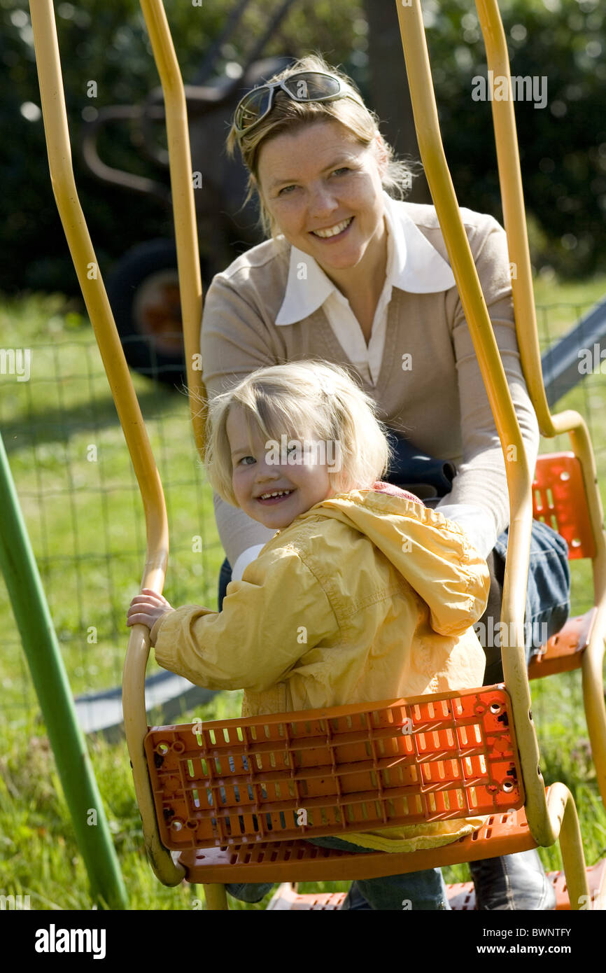 Swing and toddler girl and mum Stock Photo