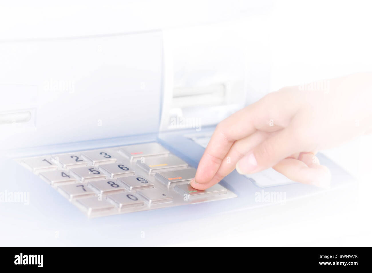 Person Entering PIN into ATM Stock Photo