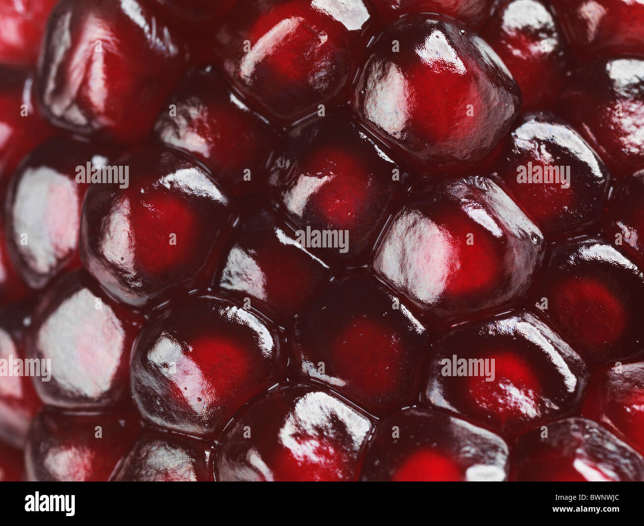 Closeup of red pomegranate arils texture background Stock Photo
