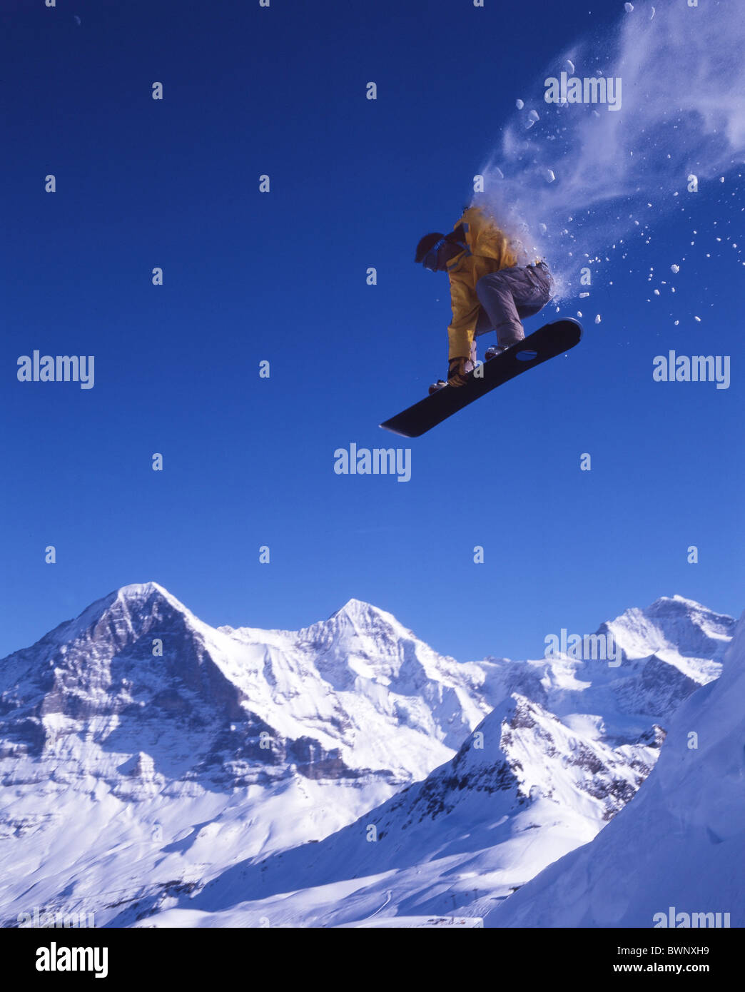 Switzerland Europe Bernese Oberland Snowboard Snowboarder Snowboarding Jump Jumping Eiger Monch Jungfrau Ca Stock Photo