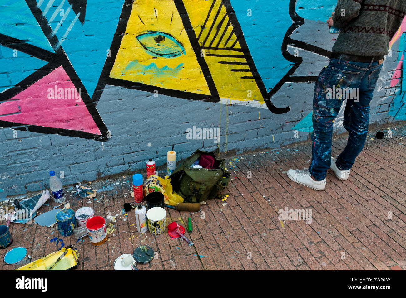 A Colombian artist paints graffiti on the wall in La Candelaria, Bogota. Stock Photo