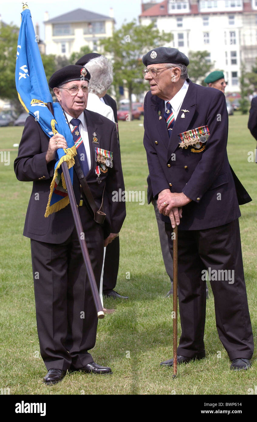 Elderly Veterans of the D-Day Landings with medals, berets, walking sticks and flag at the 60th Anniversary Commemorations Stock Photo
