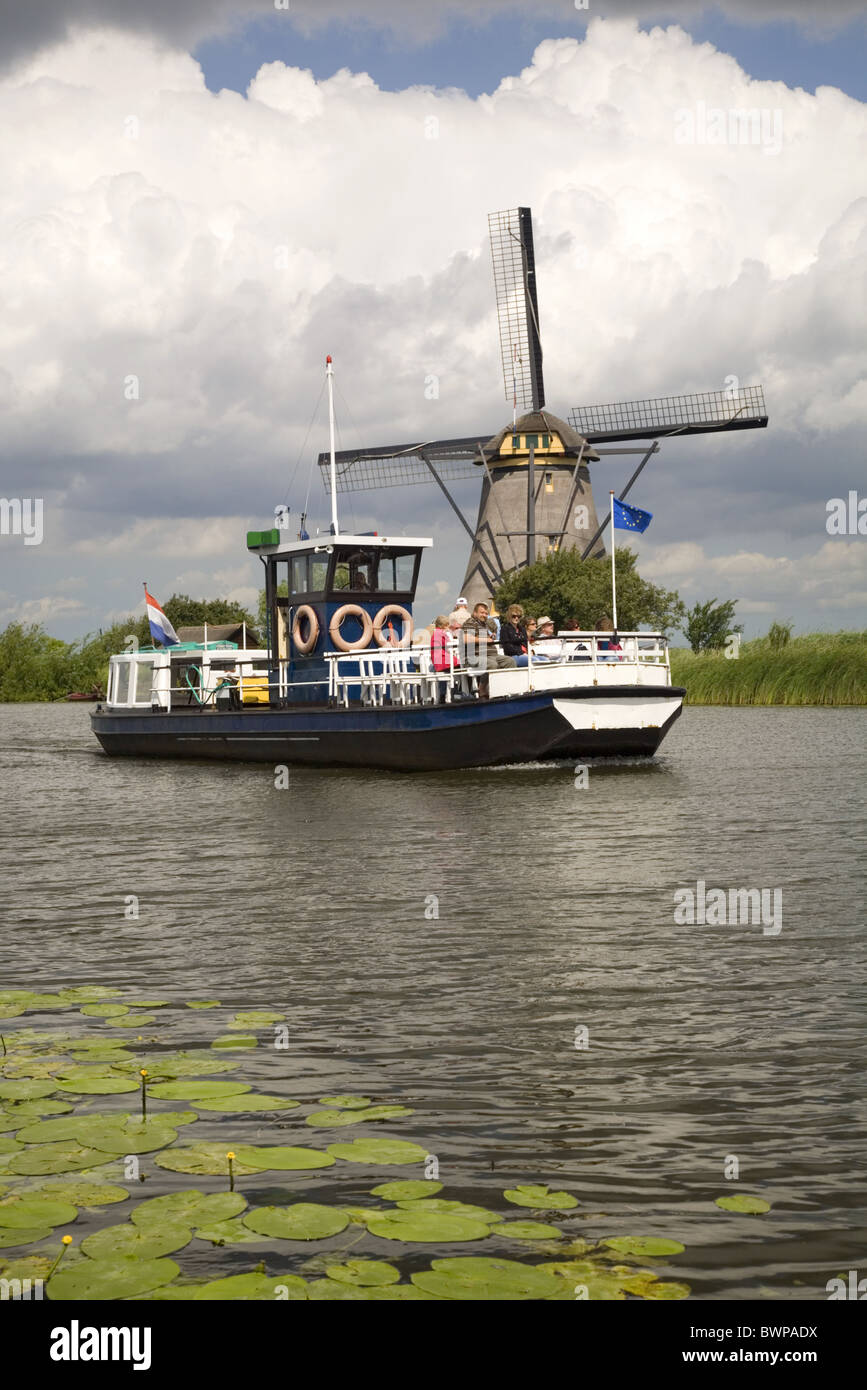 Windmill and round-trip boat of the Unesco World Heritage Site Kinderdijk, Alblasserwaard, South-Holland, Netherlands Stock Photo