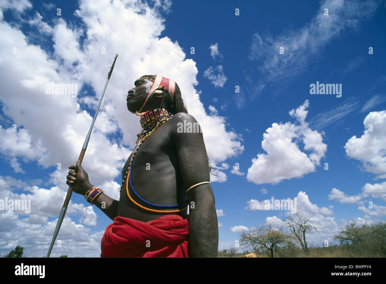 Kenya Samburu tribe Africa local man native natives sky warrior hunter hunting travel sun spear lance sh Stock Photo