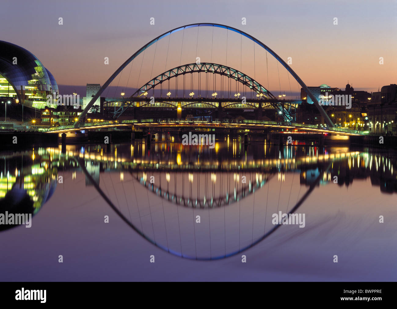 A dusk floodlit image of the Tyne Bridges and the River Tyne, Newcastle upon Tyne Stock Photo