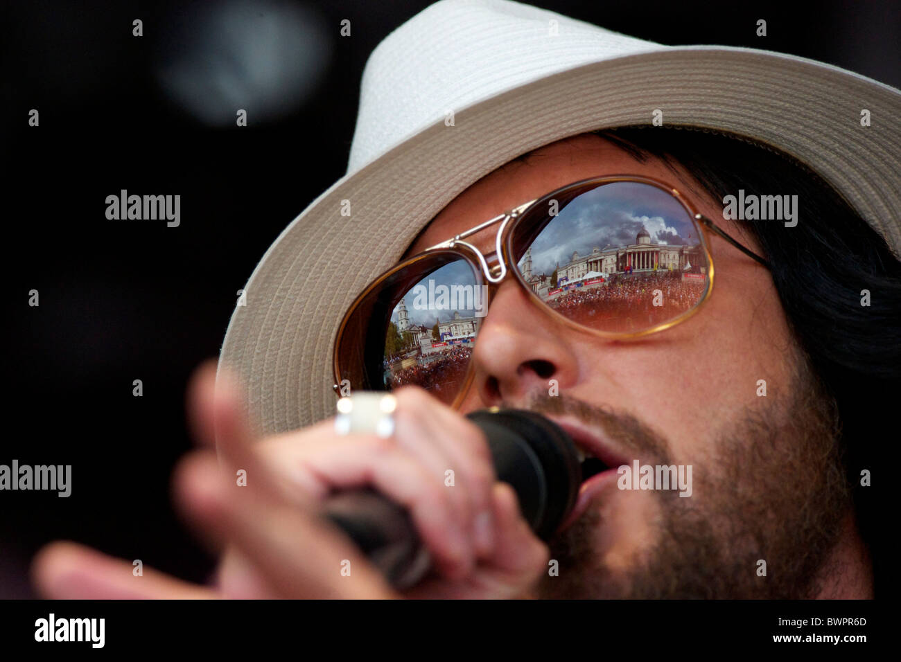 The National Gallery of Art and Trafalgar Square are reflected in the sunglasses of Cuban Brother's lead singer Miguel Stock Photo