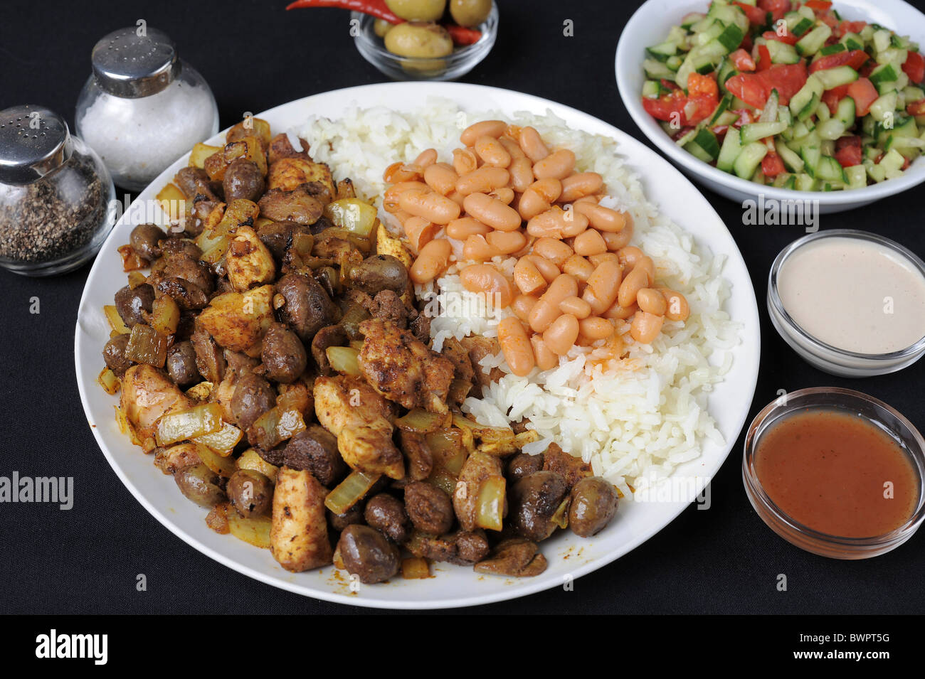 Meorav Yerushalmi (lit. Jerusalem Mix) Spicy Chicken meat and internal organs with rice and beans Stock Photo