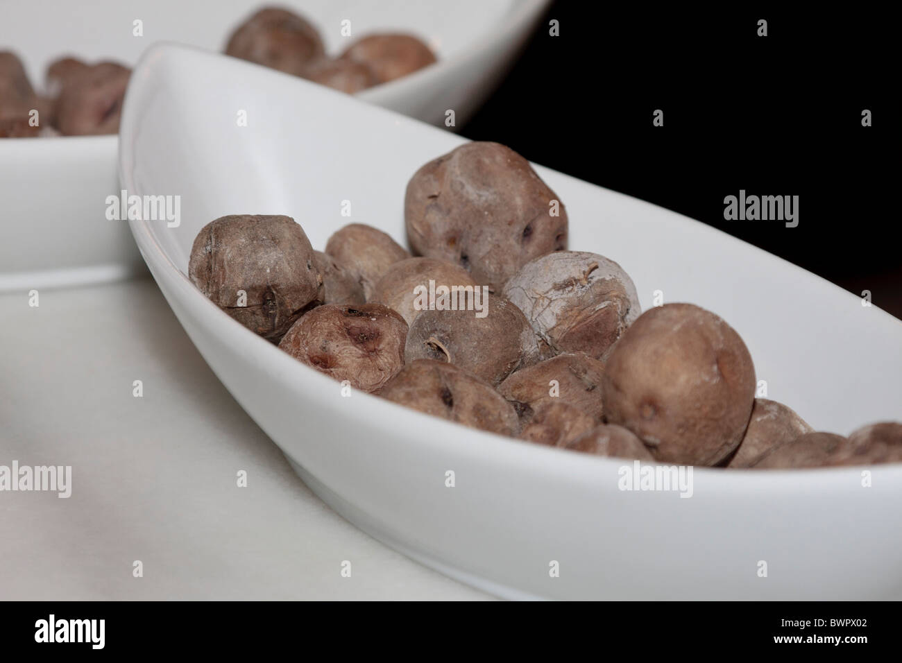 A boat shaped dish of Canarian potatos Papas Arrugadas ready to be served in a restaurant Stock Photo