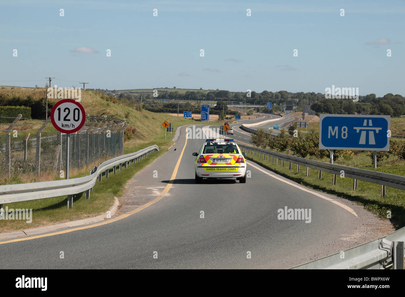 Irish Gardai (Garda) Police car entering slip road to the new M8 motorway linking Dublin with the south east of Ireland. Stock Photo