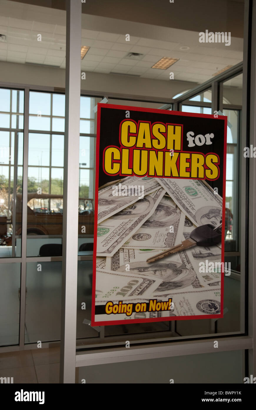 'Cash for Clunkers' sign on window of sales office at car dealership during the promotion to jump-start stagnant auto sales Stock Photo