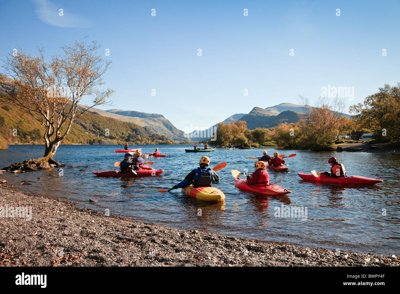 Young people learning canoeing in kayaks on Llyn Padarn Lake in