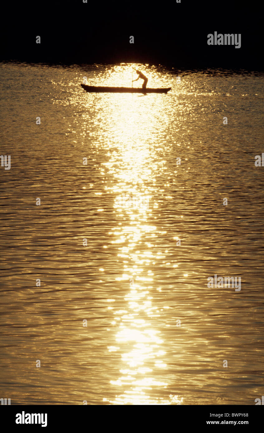 A man poling up the Rio Grijalva in a dugout canoe Stock Photo