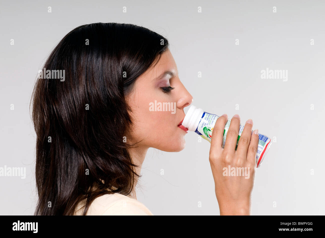 Portrait of a young woman drinking yogurt Stock Photo