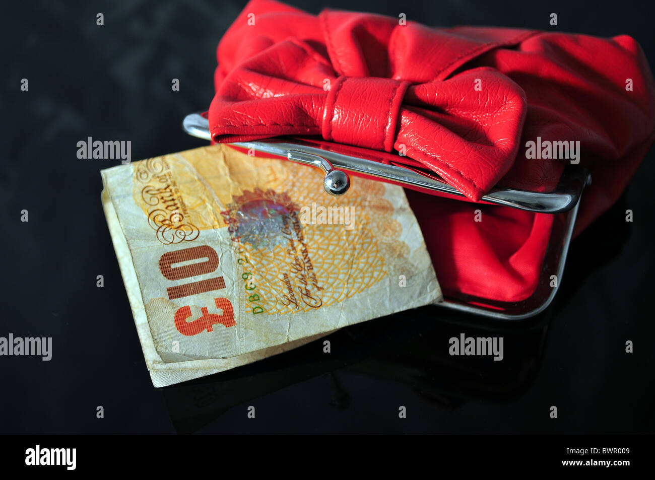 A red purse with a ten pound note Stock Photo