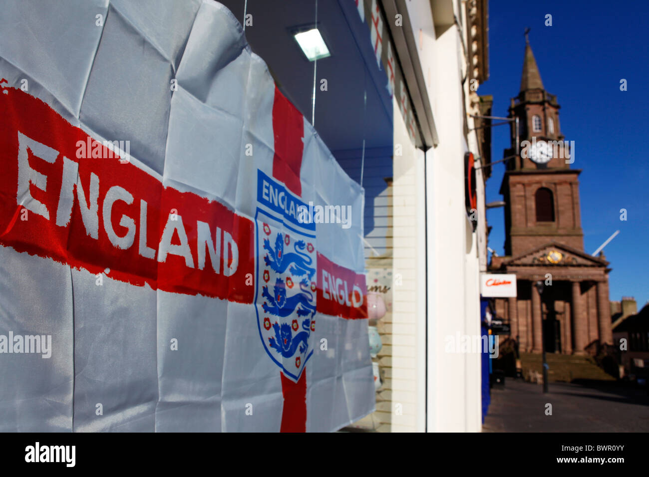 An England flag, bearing the crest of the England Football Association is displayed in a in a shop window in Berwick. Stock Photo