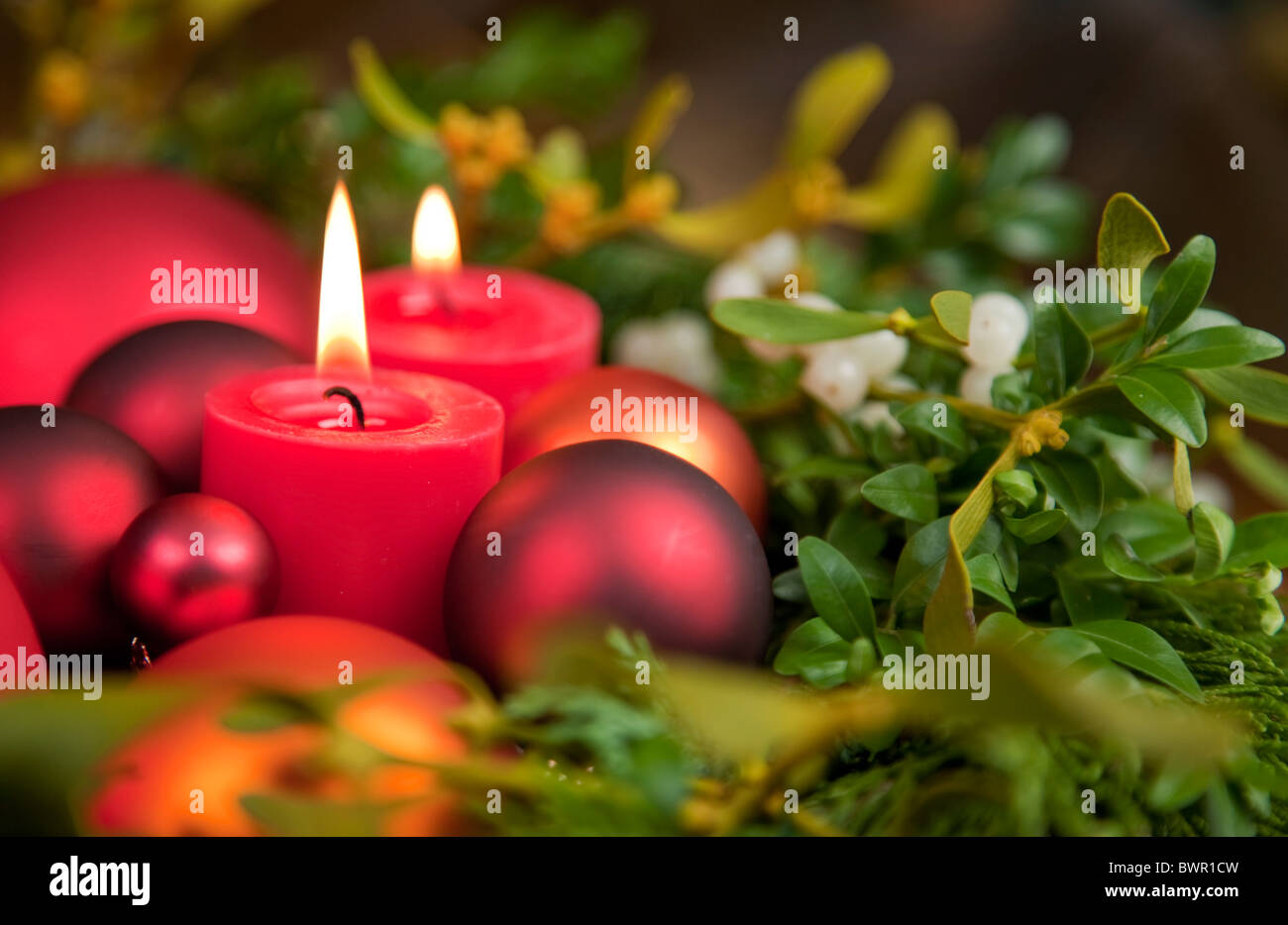 Christmas decoration with mistletoe and two candles Stock Photo