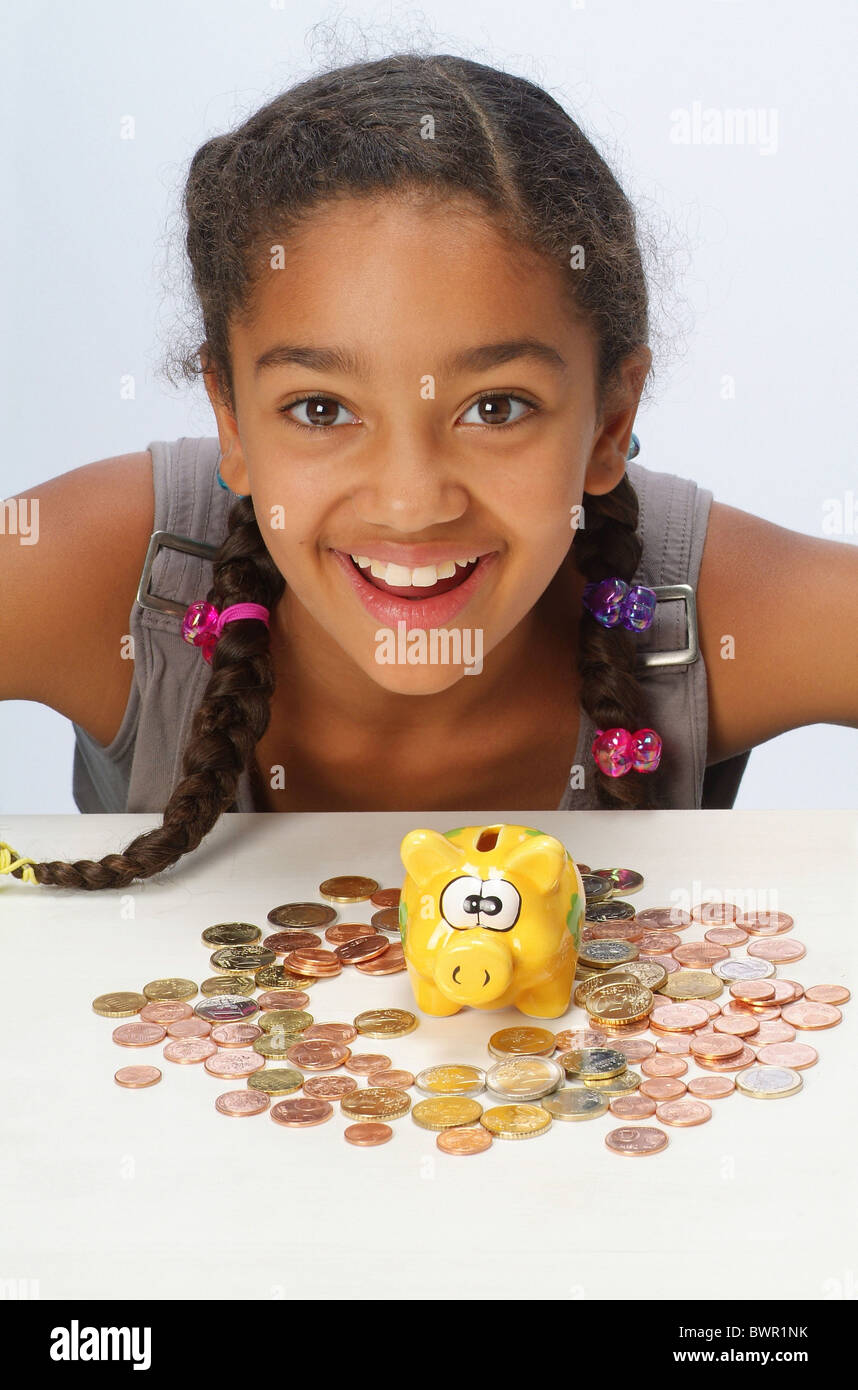 A girl with her savings and a piggy bank Stock Photo - Alamy