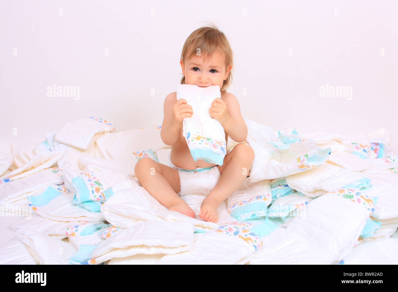Toddler child children one girl sit sitting nappy nappies diaper diapers studio portrait white