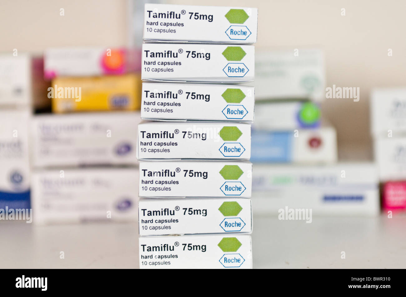 Stack of boxes of Tamiflu anti-viral tablets on a shelf in a pharmacy Stock Photo