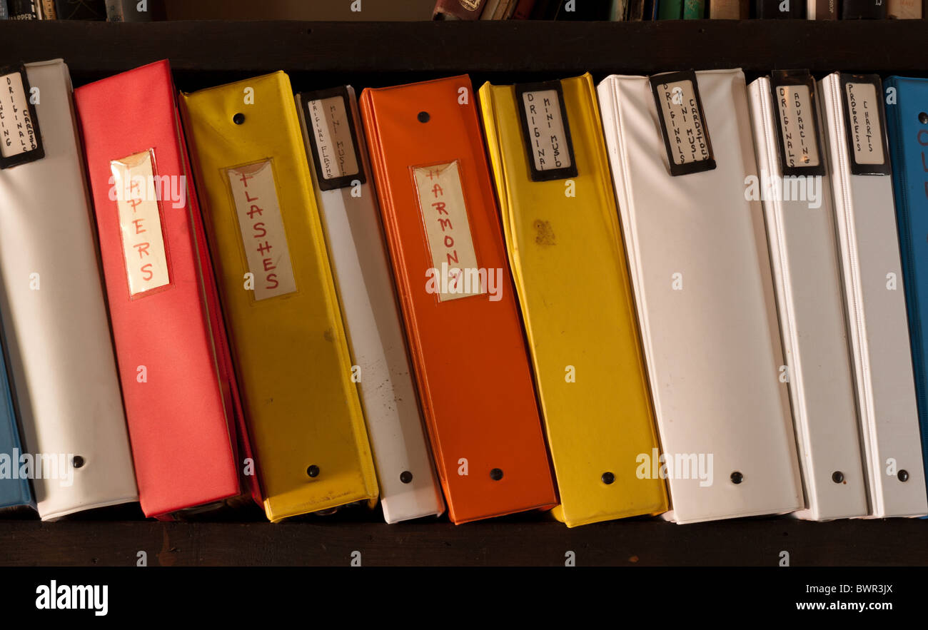 three ring binders on a shelf with name tags Stock Photo Alamy