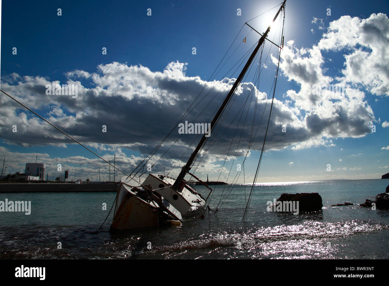 Contre-jour view of a wrecked sailing boat Stock Photo
