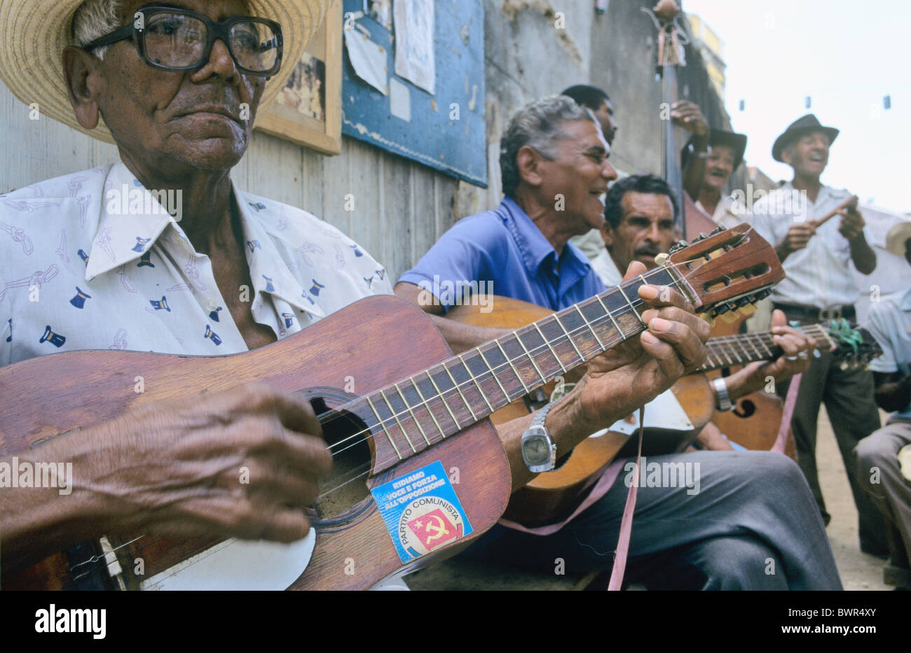 Cuba Trinidad city town Trinidad ensemble elderly men playing traditional Cuban music tourists sticker commu Stock Photo