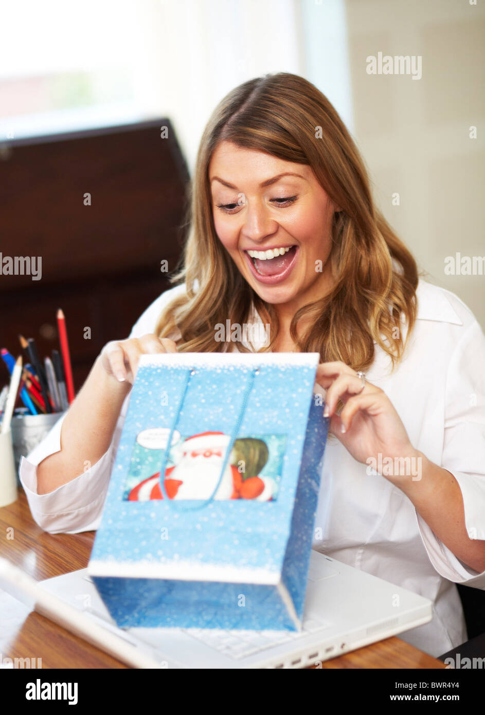 Girls in office opening secret Santa presents Stock Photo