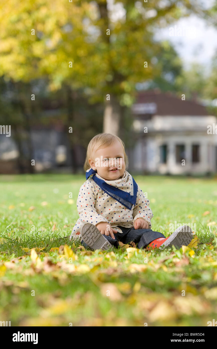 Little girl in the park in autumn Stock Photo - Alamy