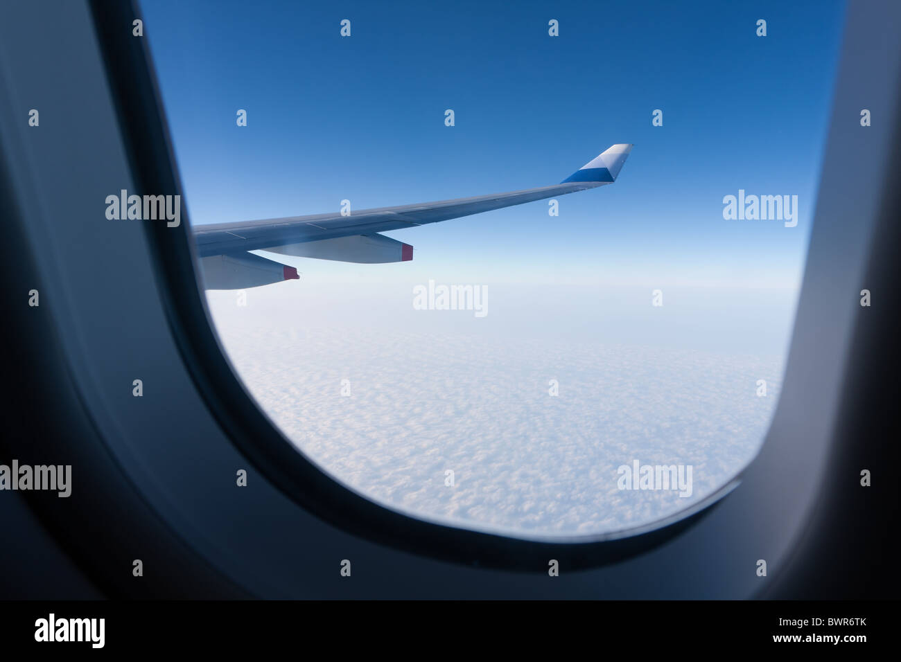 Winglet of an aircraft Airbus A330-300 of China Airlines CI-917 in flight, seen through the window, against blue sky, fly from Taiwan to Hong Kong Stock Photo