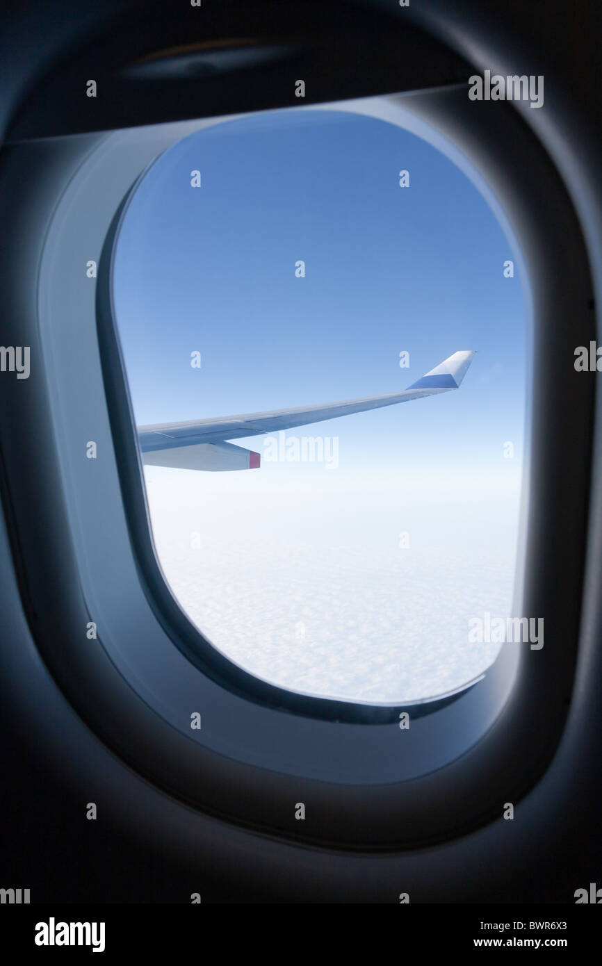 Winglet of an aircraft Airbus A330-300 of China Airlines CI-917 in flight, seen through the window, against blue sky, fly from Taiwan to Hong Kong Stock Photo