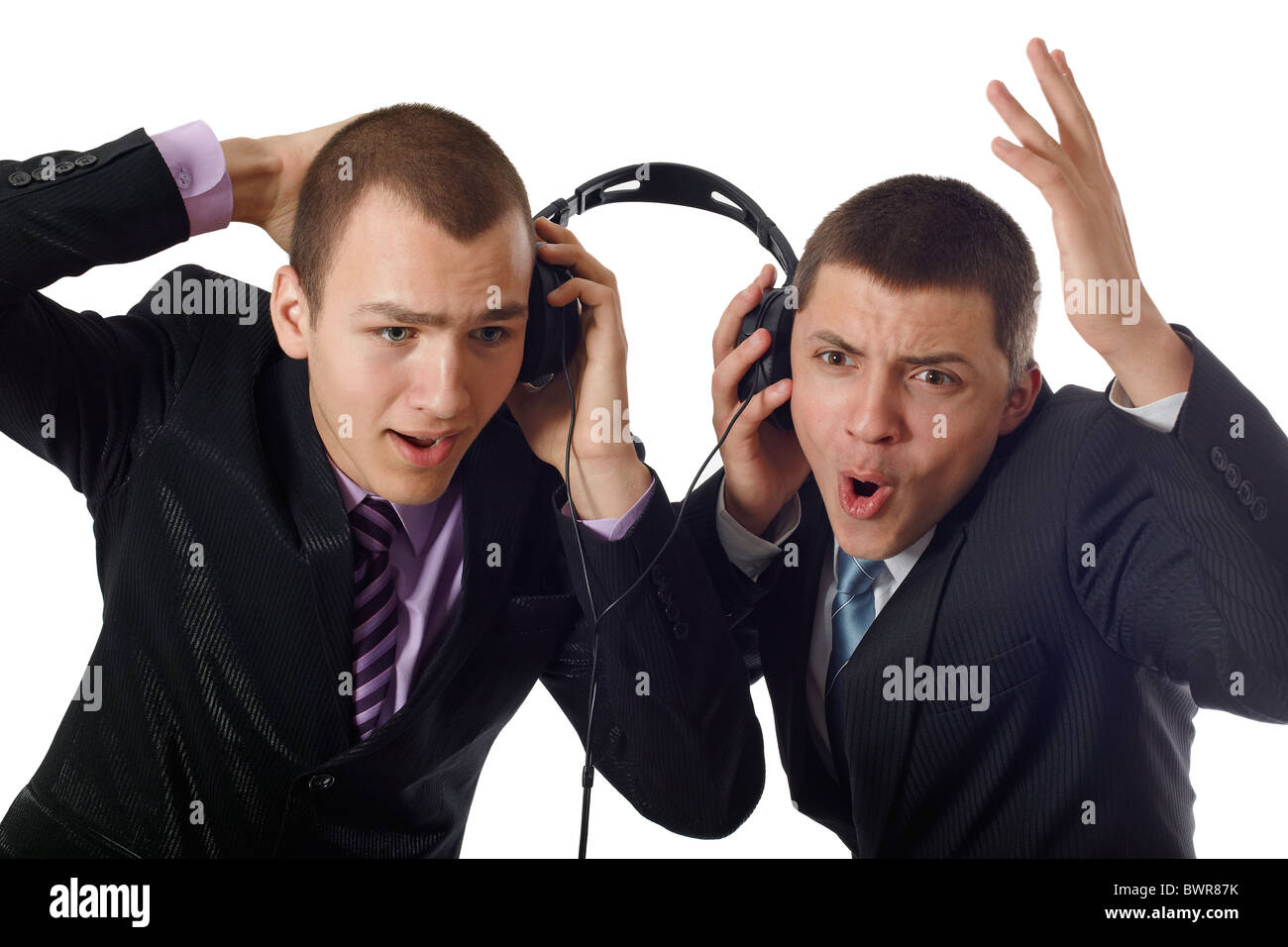 Two young people listening on headphone about something and wondering Stock Photo
