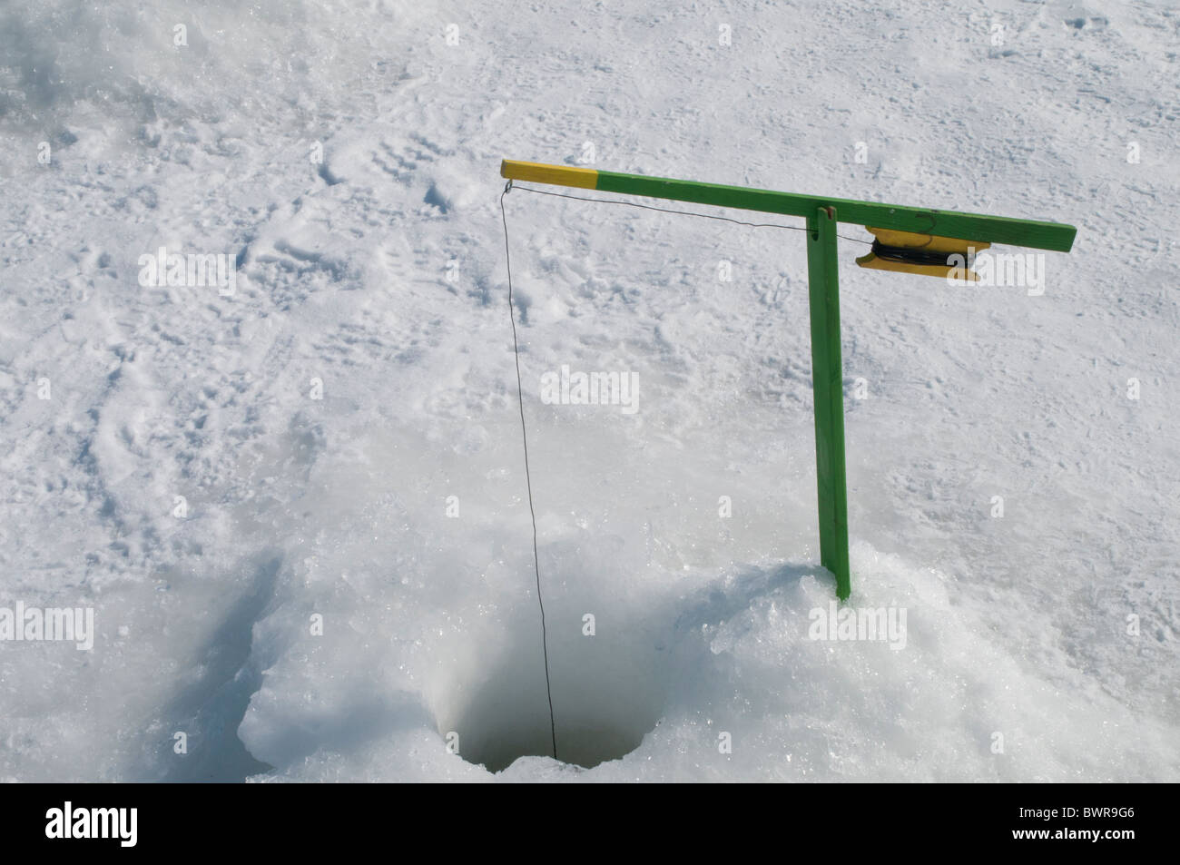 Ice fishing in Quebec, Canada - the rod and bait is all set up to catch fish  in a dugout of a frozen river bed Stock Photo - Alamy