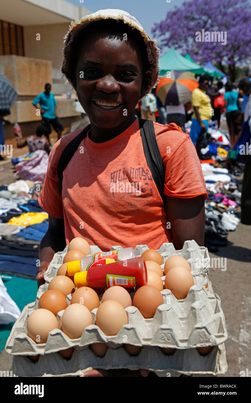 A young woman sells eggs at a market in Bulawayo, Zimbabwe Stock Photo