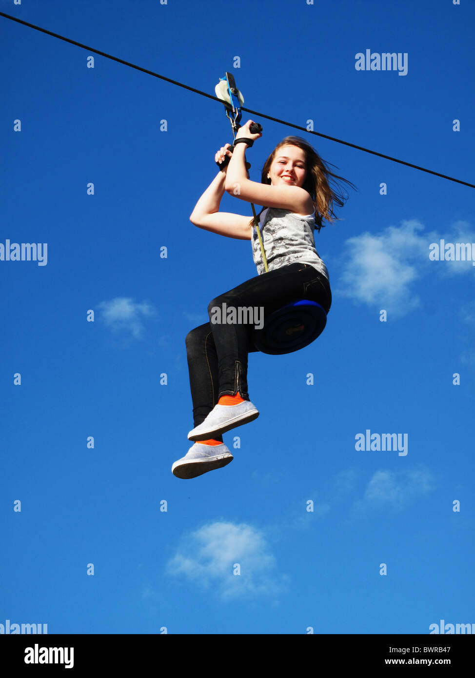 Young girl on zip wire Stock Photo