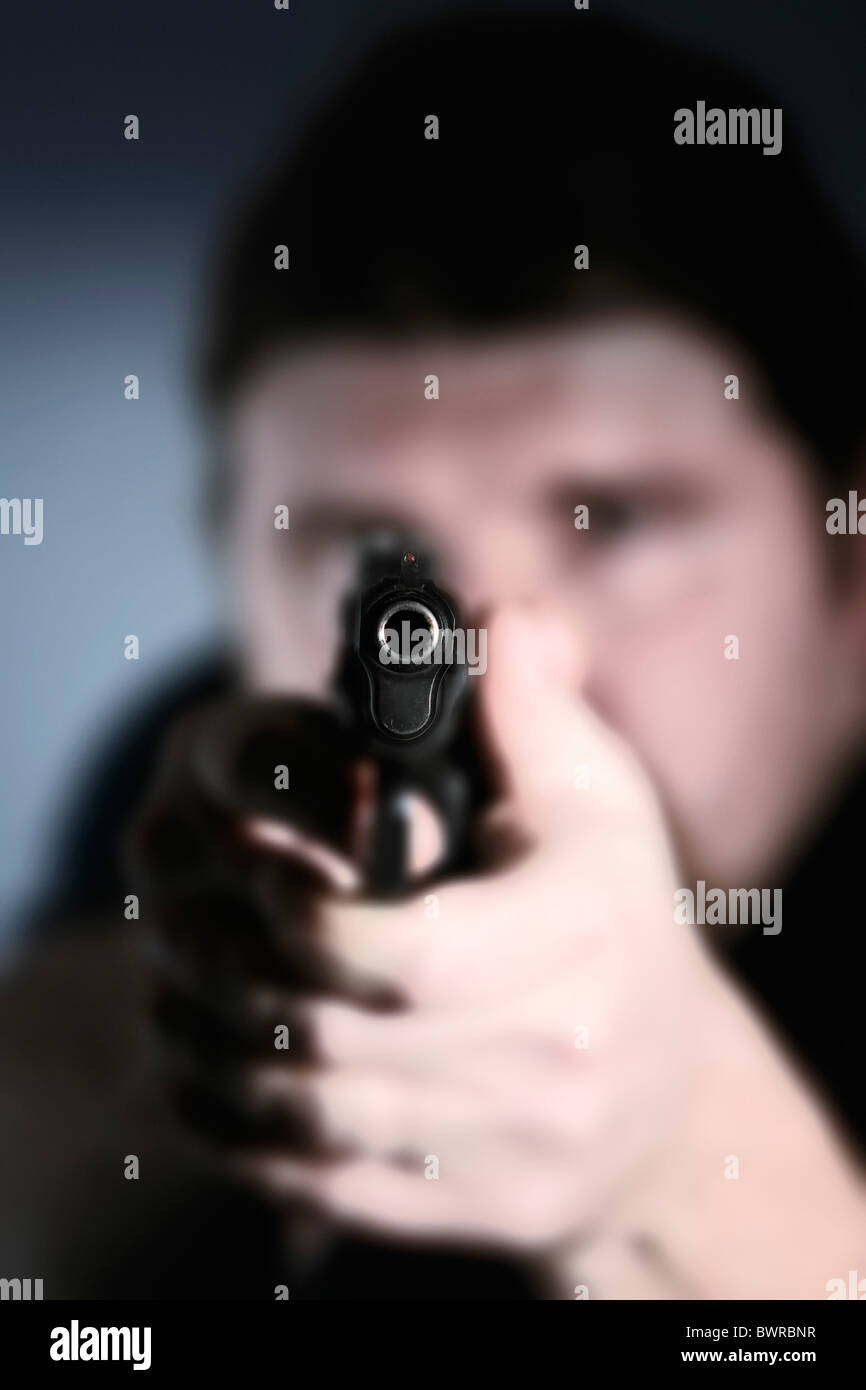 Gunman adult adults aiming alone arm arms caucasian crime criminal criminals firearm firearms firing gra Stock Photo