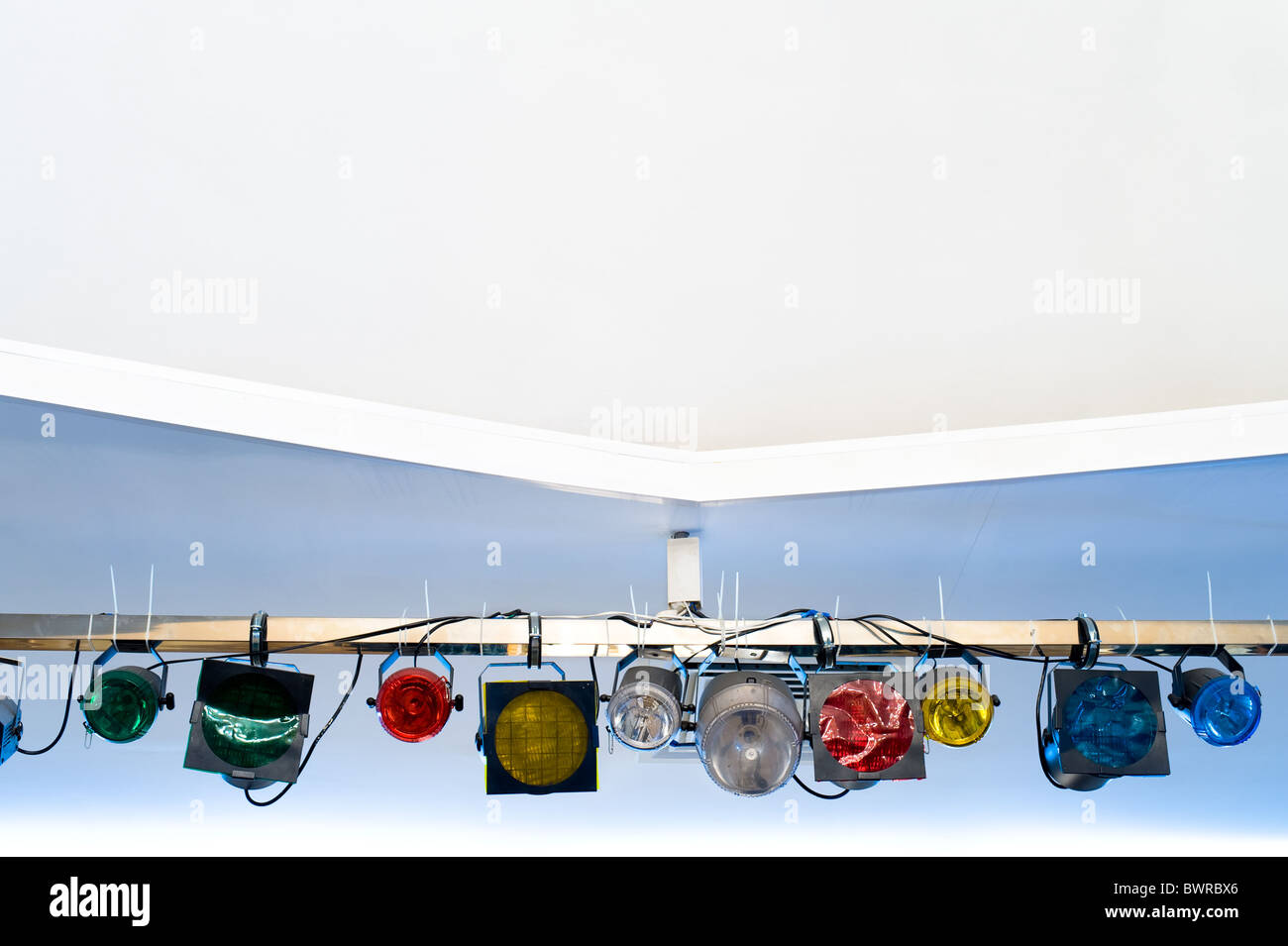 set of stage suspended coloured spotlights under ceiling with copy